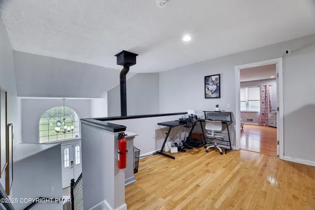 a view of a livingroom with furniture and workspace