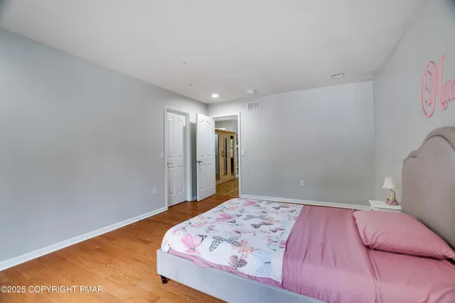 a spacious bedroom with a bed and a large window