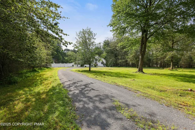 a view of a house with a backyard