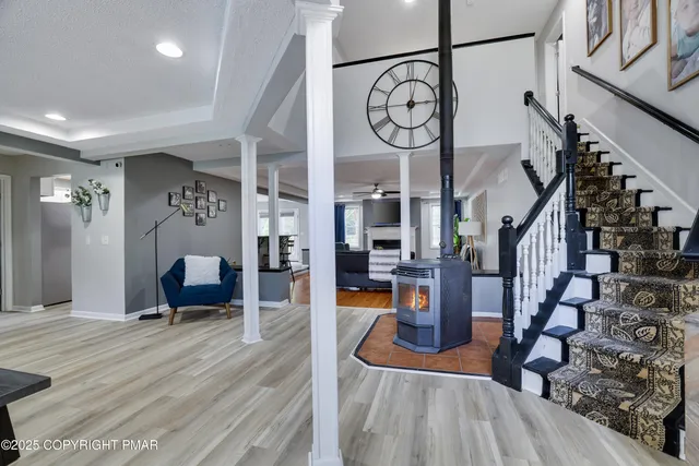 a kitchen with kitchen island granite countertop a sink a counter space appliances and cabinets