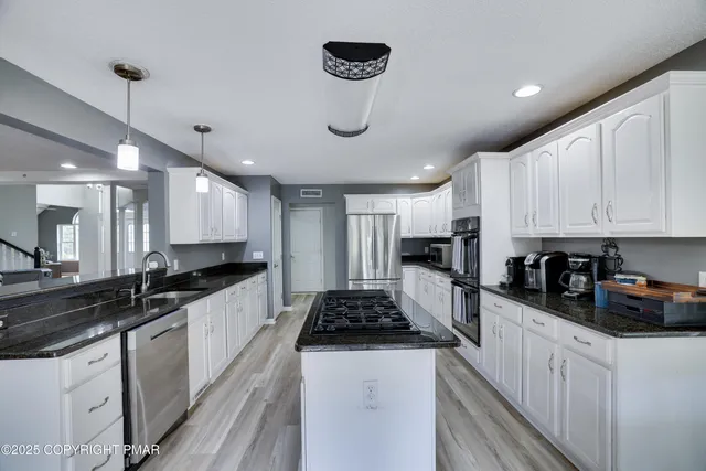a kitchen with a table and chairs in it