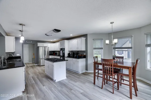 a view of a workspace with furniture window and wooden floor