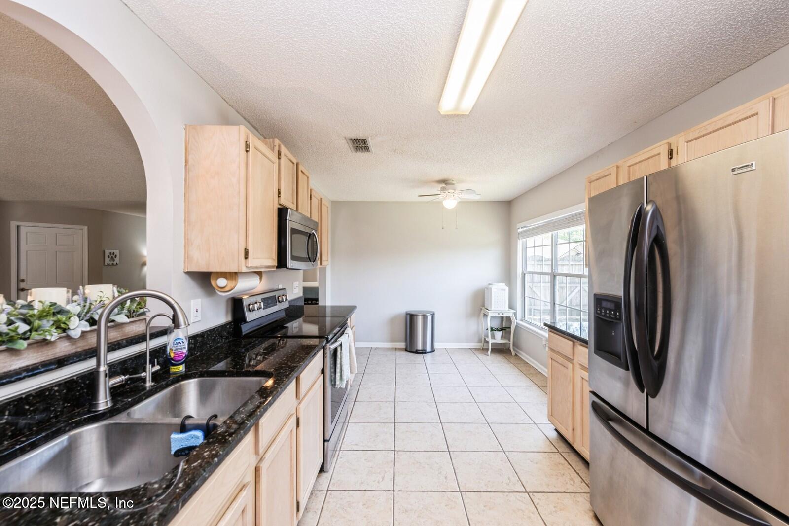1962 Little River Drive Fleming Island, FL 32003 - Photo 13 of 29 a kitchen with granite countertop a sink stove and refrigerator