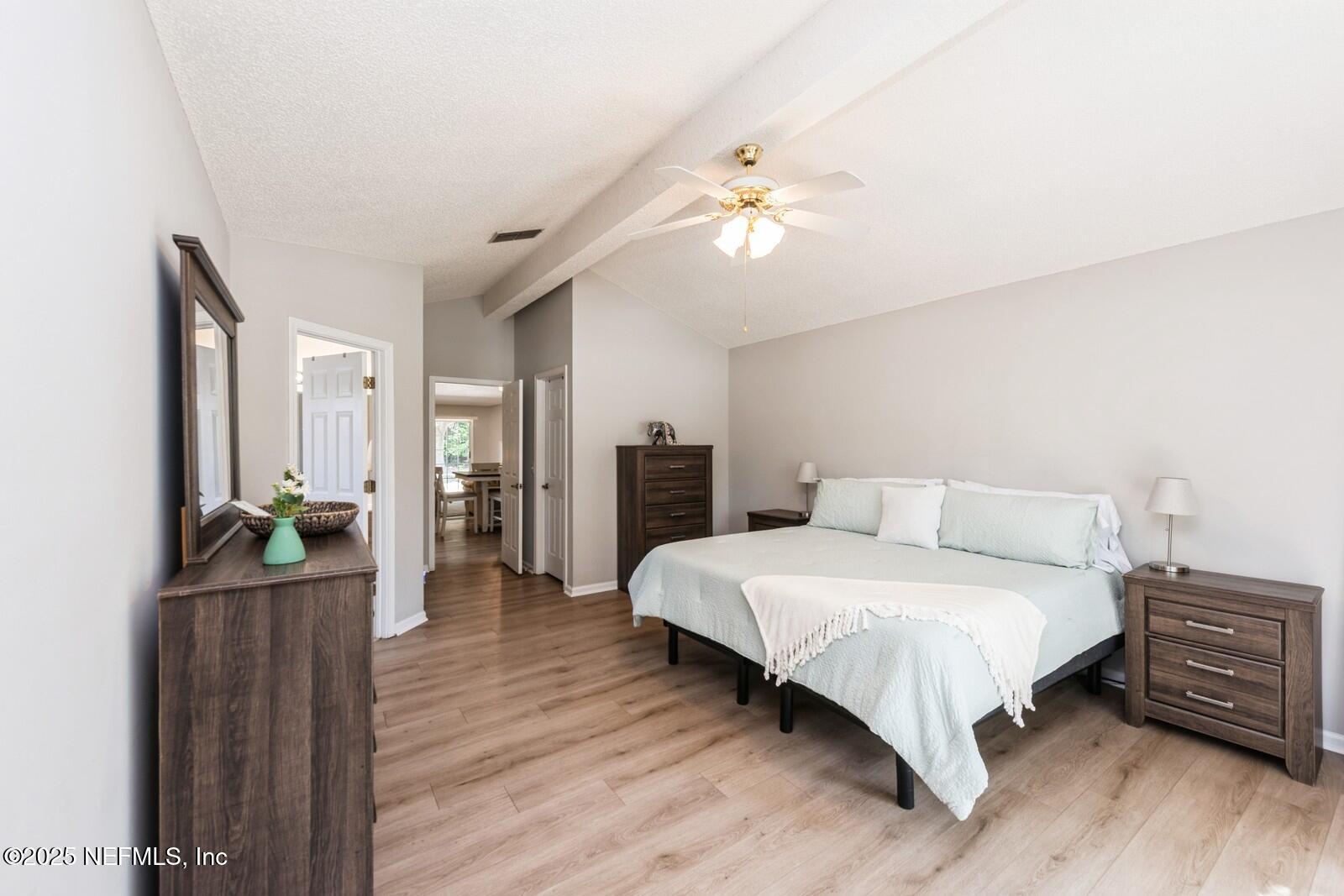 1962 Little River Drive Fleming Island, FL 32003 - Photo 17 of 29 a bedroom with a bed and wooden floor