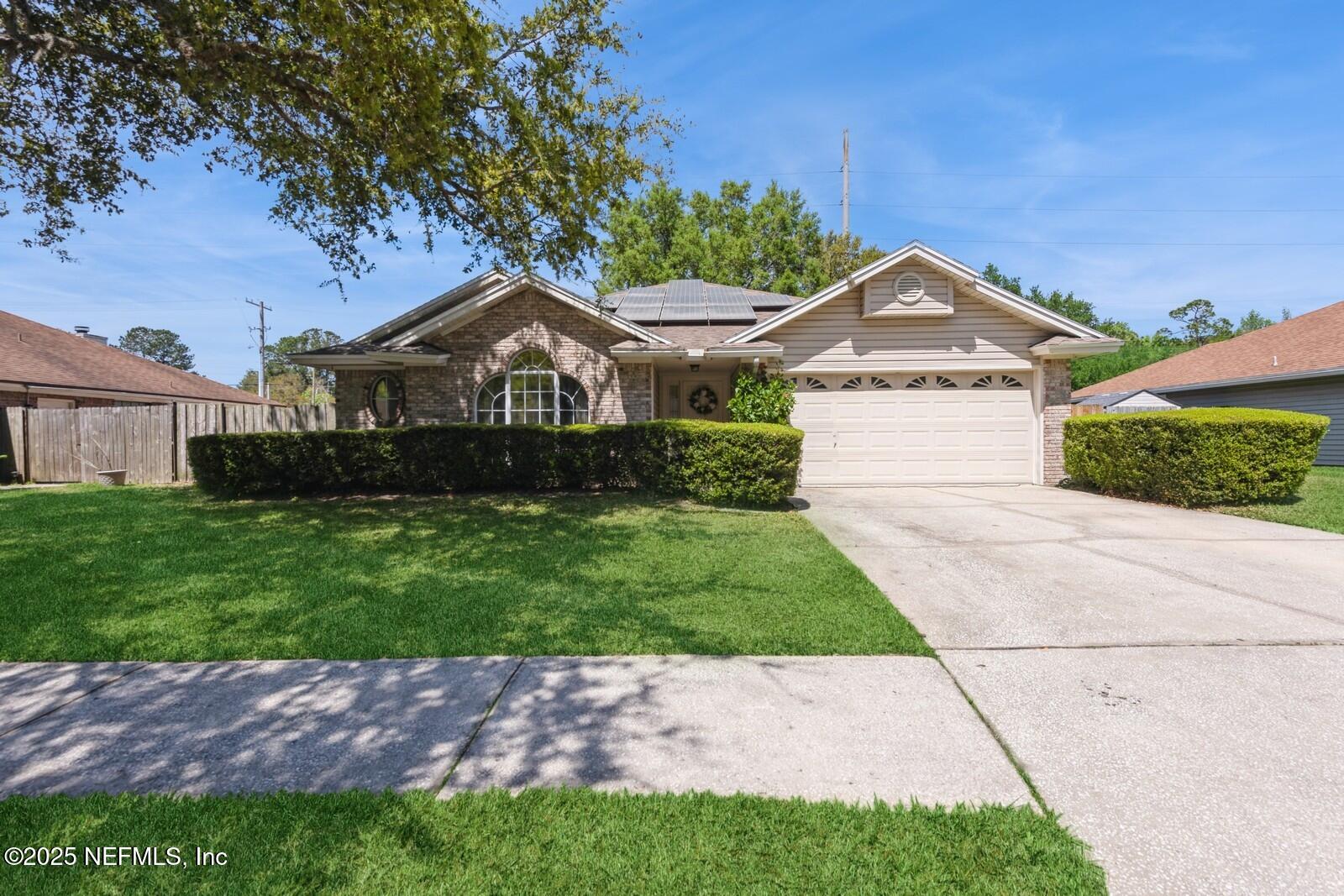 1962 Little River Drive Fleming Island, FL 32003 - Photo 2 of 29 a front view of a house with a garden
