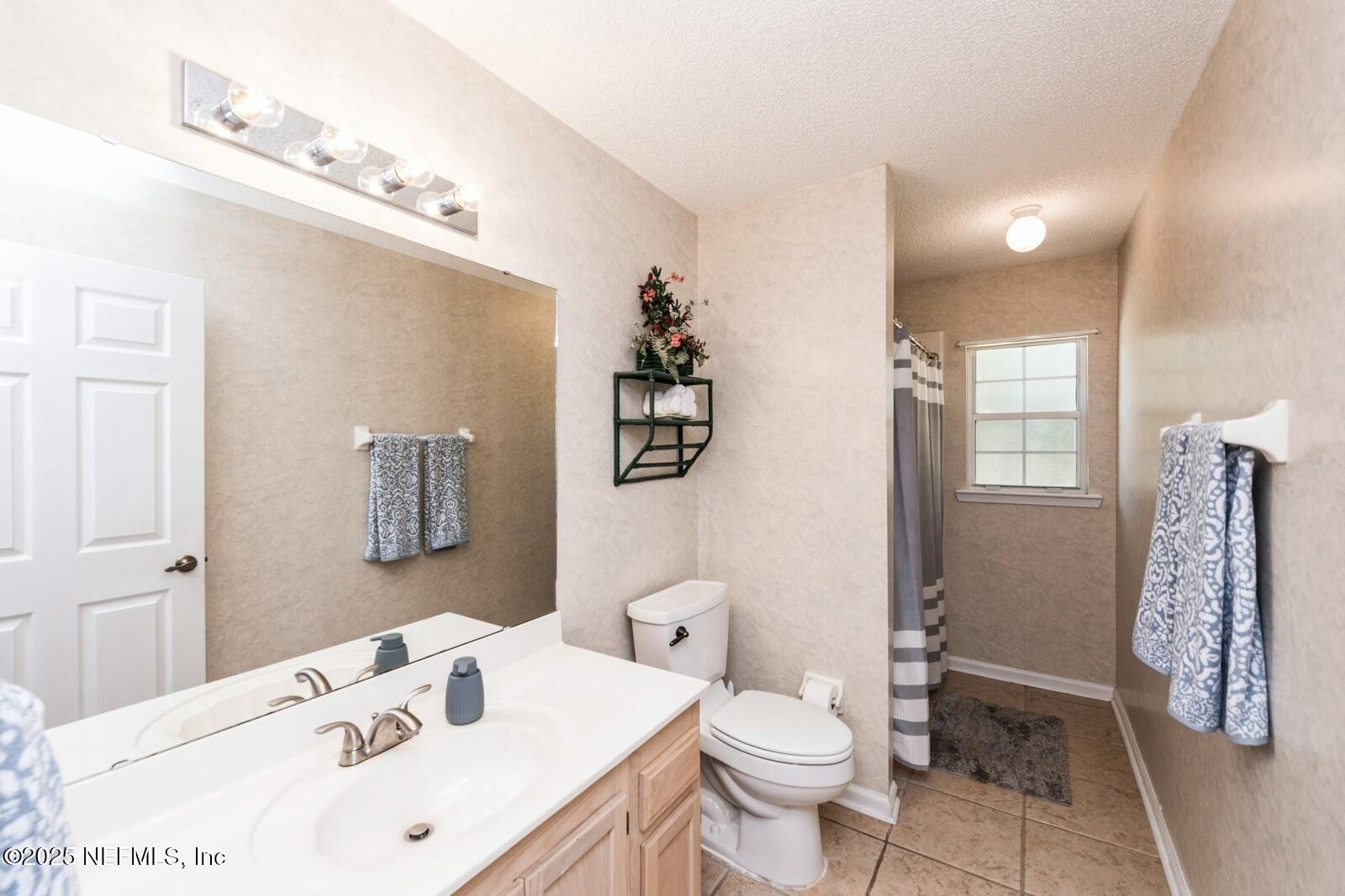 1962 Little River Drive Fleming Island, FL 32003 - Photo 24 of 29 a bathroom with a sink a toilet and shower
