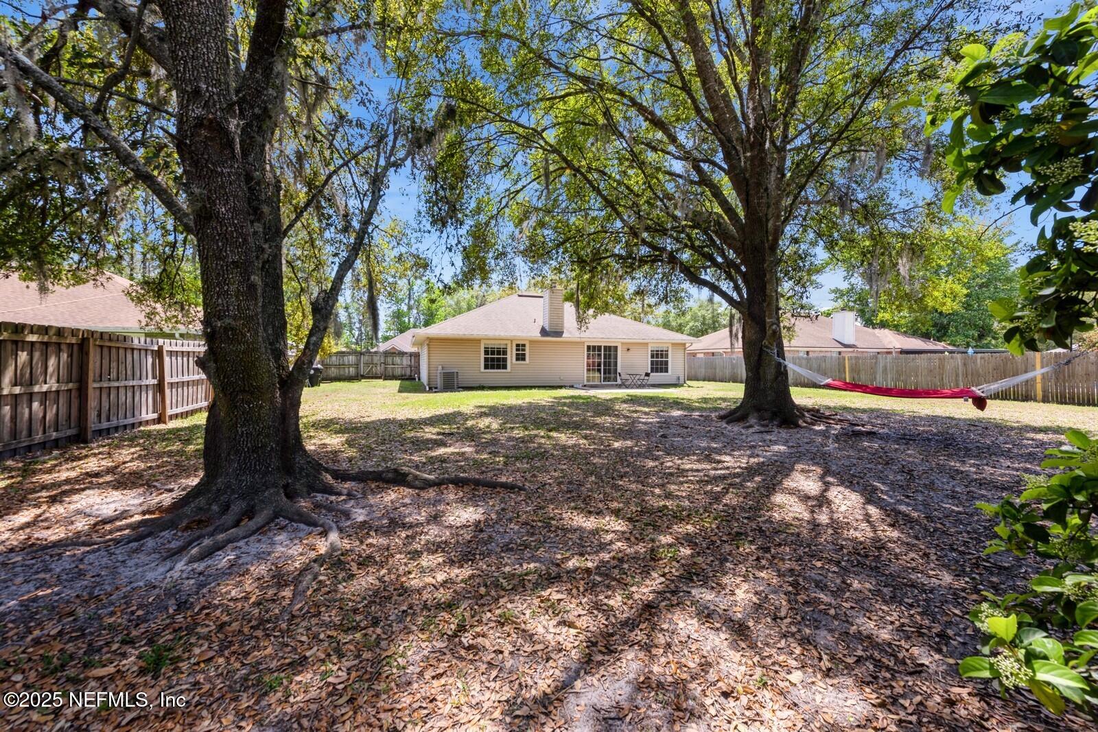 1962 Little River Drive Fleming Island, FL 32003 - Photo 28 of 29 a view of backyard with large trees and wooden fence