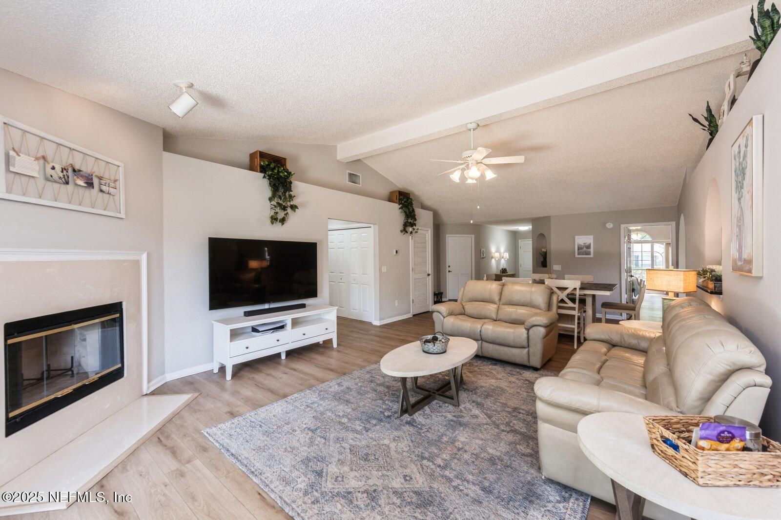 1962 Little River Drive Fleming Island, FL 32003 - Photo 8 of 29 a living room with furniture a flat screen tv and a fireplace