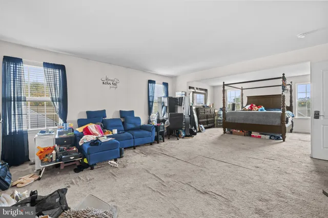 a living room with furniture a window and a flat screen tv