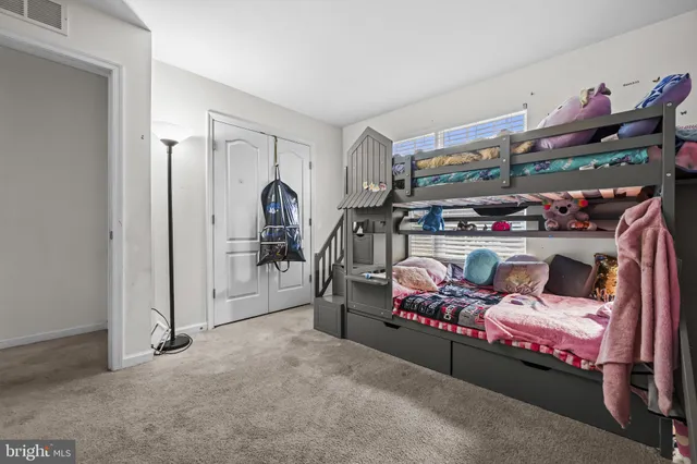 a bedroom with a bed and a walk in closet