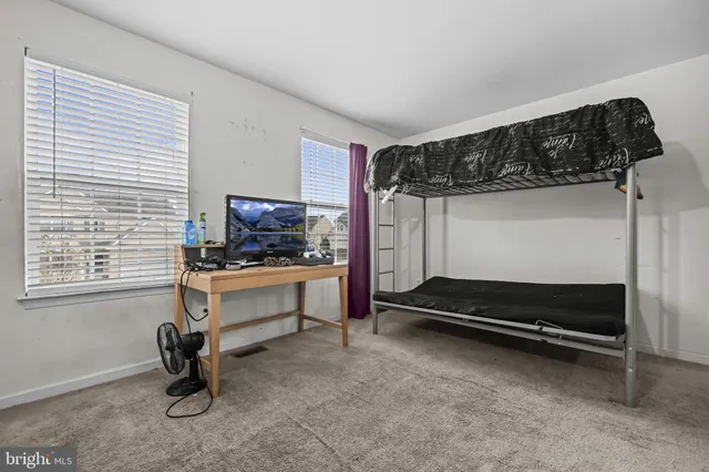 a bedroom with furniture and a window