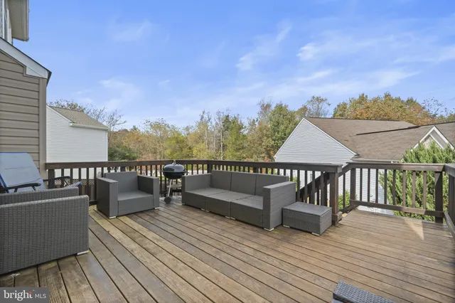 a view of a balcony with wooden floor and iron stairs