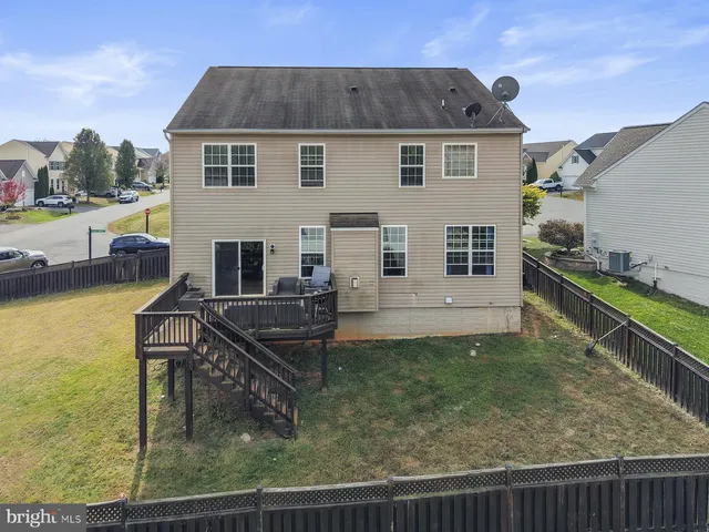 a view of a house with backyard porch and sitting area