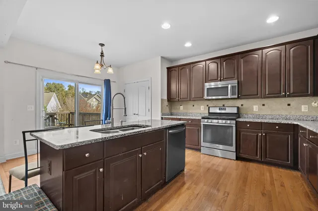 a kitchen with a sink stove and microwave