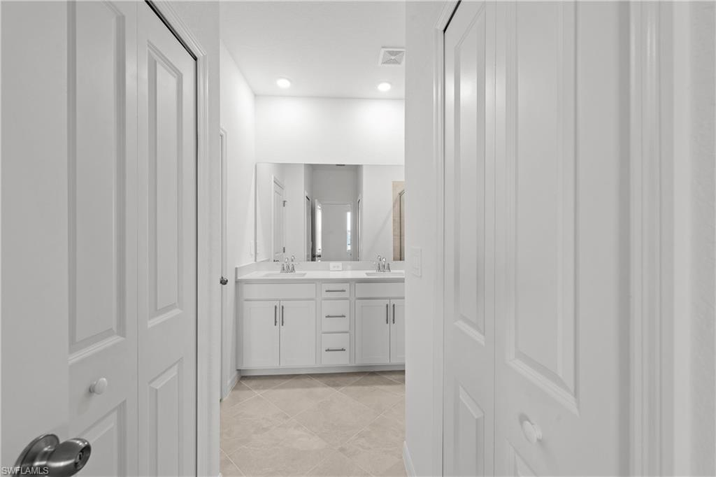 15003 White Pearl Road Babcock Ranch, FL 33982 - Photo 42 of 43 a bathroom with a granite countertop sink and a mirror