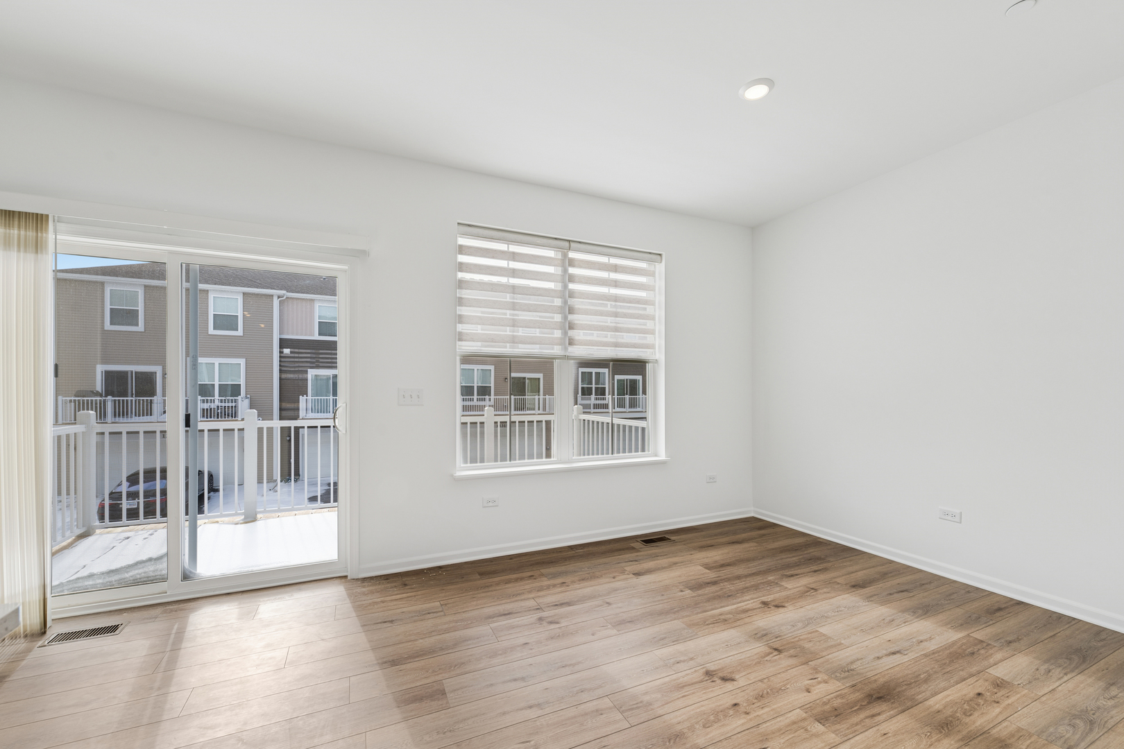 12312 Tinsley Street Huntley, IL 60142 - Photo 12 of 24 an empty room with wooden floor and windows