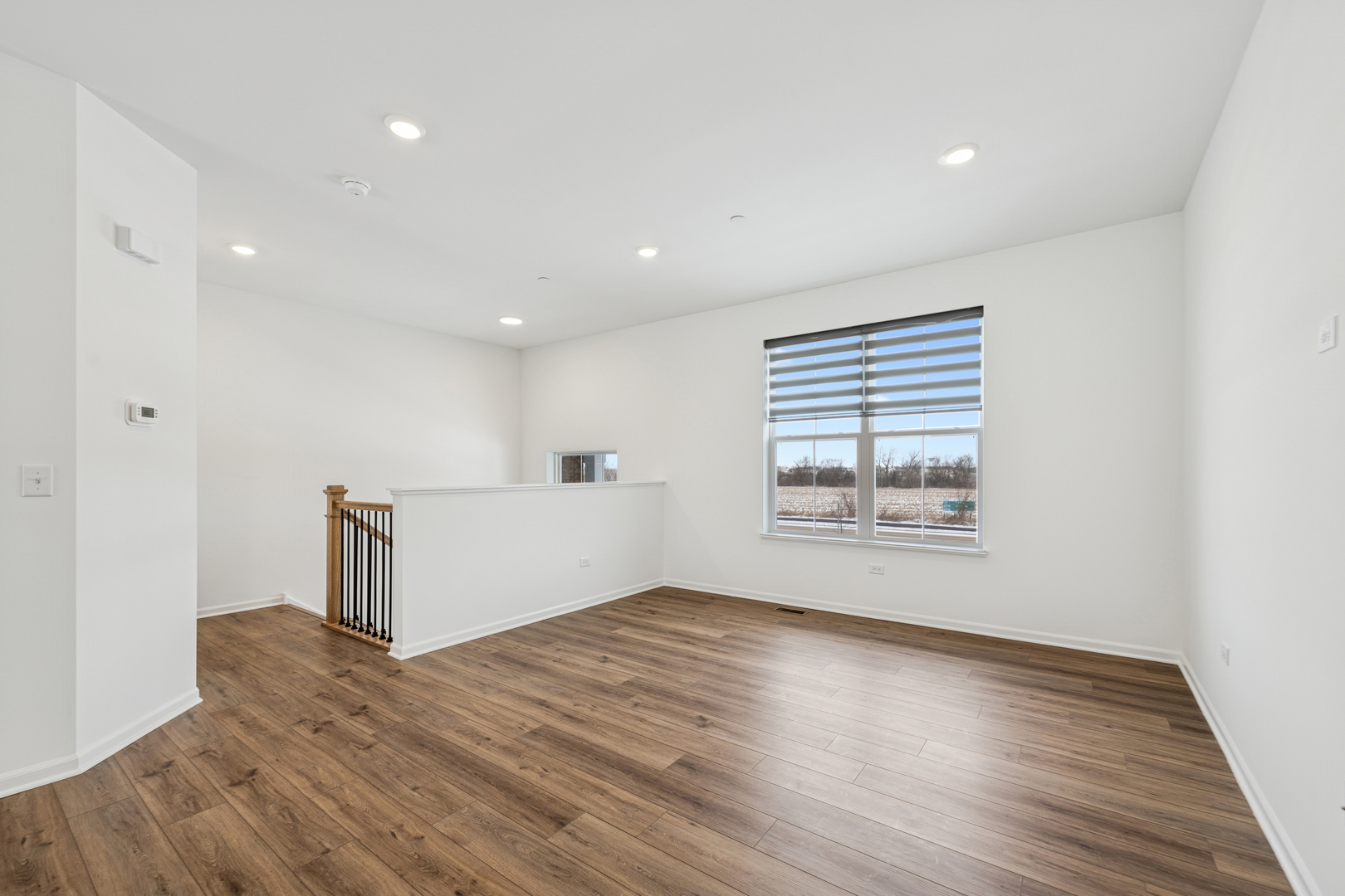 12312 Tinsley Street Huntley, IL 60142 - Photo 8 of 24 a view of empty room with wooden floor