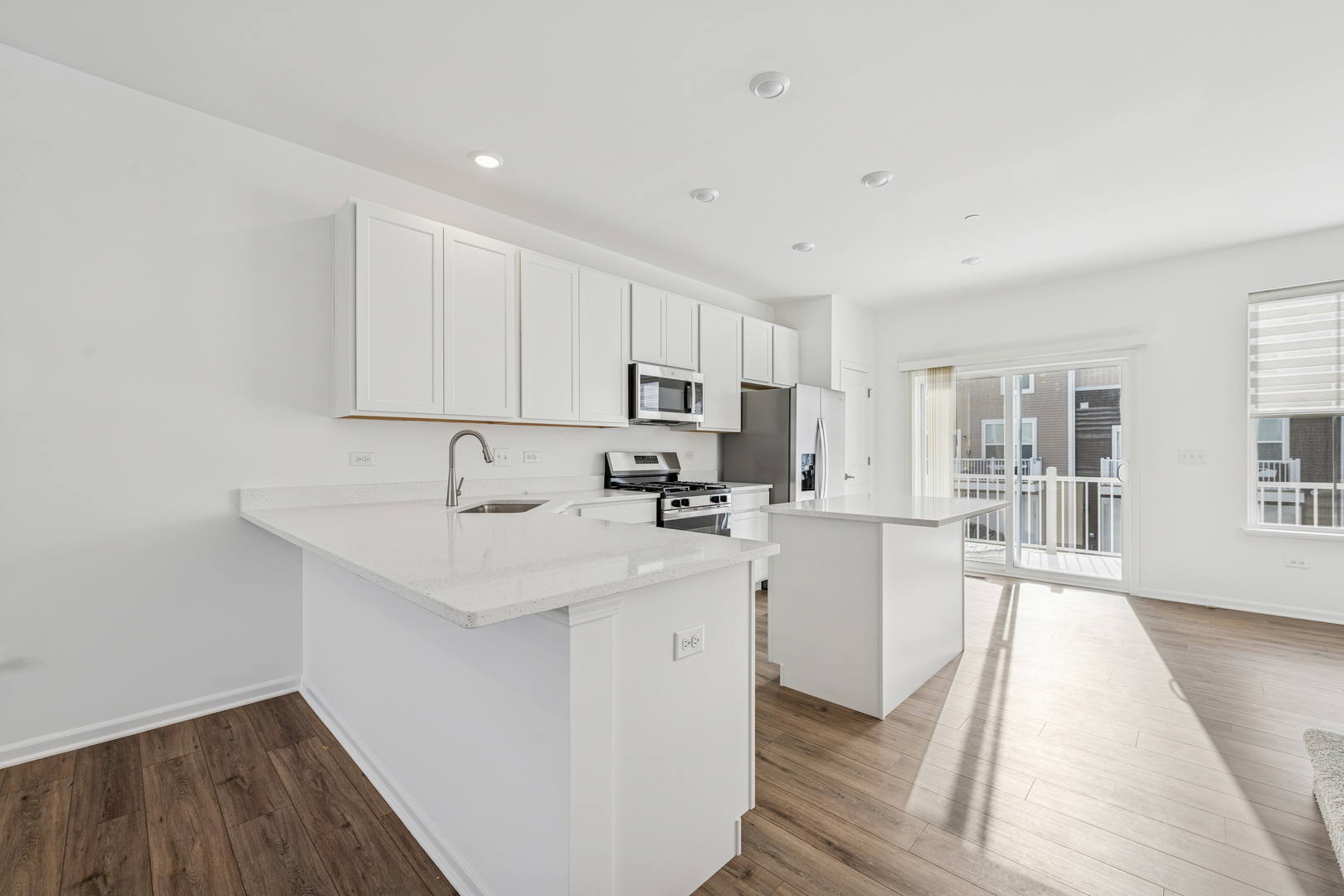 12312 Tinsley Street Huntley, IL 60142 - Photo 10 of 24 a kitchen with stainless steel appliances granite countertop a sink stove and refrigerator