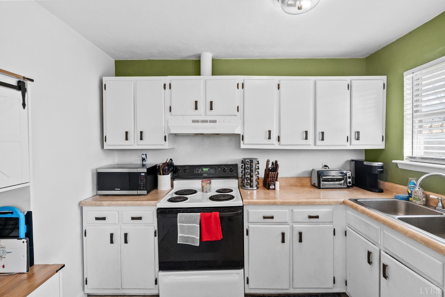 119 Dogwood Street Amherst, VA 24521 - Photo 14 of 37 a kitchen with cabinets appliances a sink and a window
