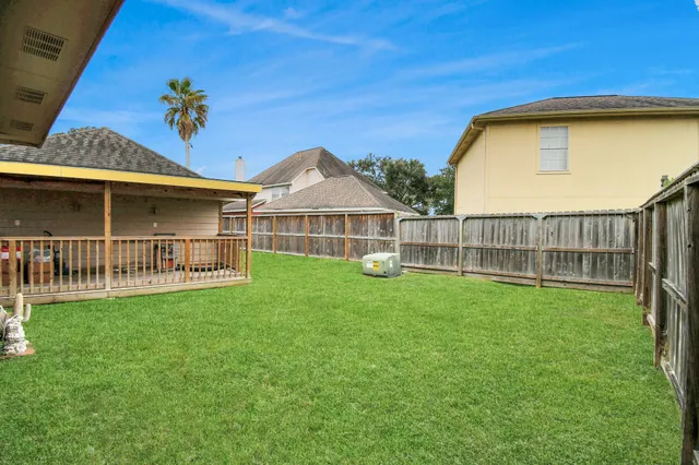 a view of a house with a backyard