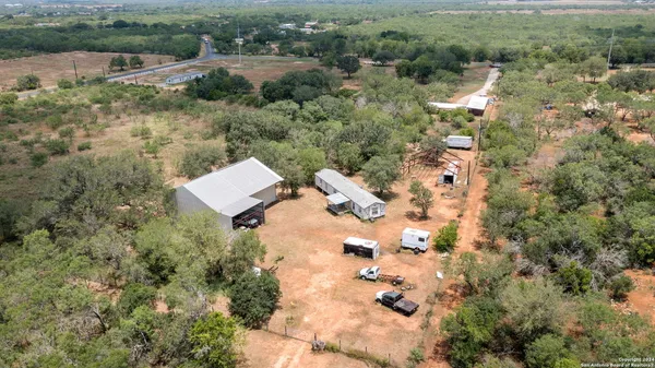 an aerial view of residential house with outdoor space and trees
