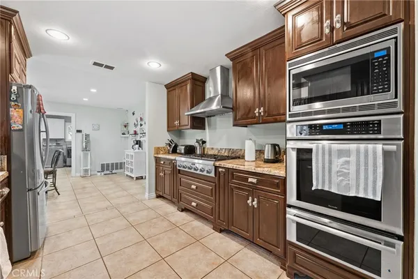 a kitchen with stainless steel appliances granite countertop a stove and a refrigerator
