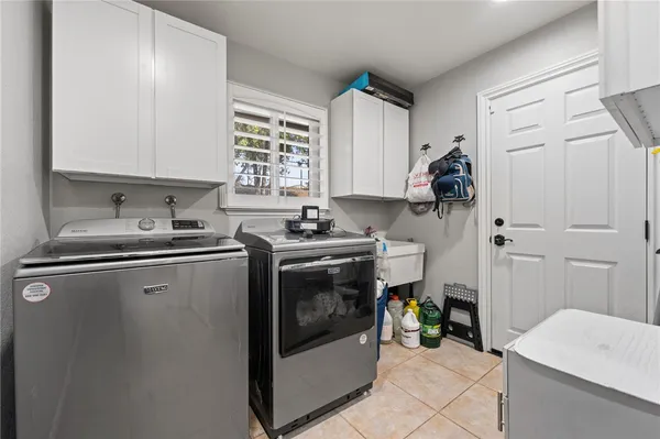 a kitchen with a sink a stove and cabinets