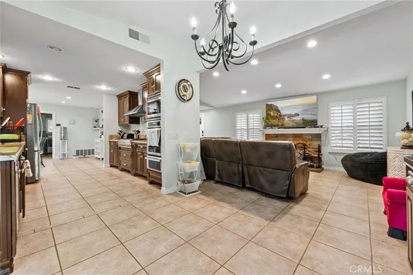 a large white kitchen with a large counter top appliances and cabinets