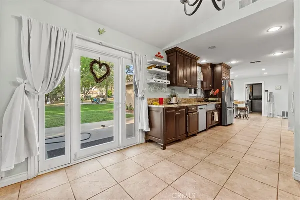a open kitchen with stainless steel appliances granite countertop a stove and a sink