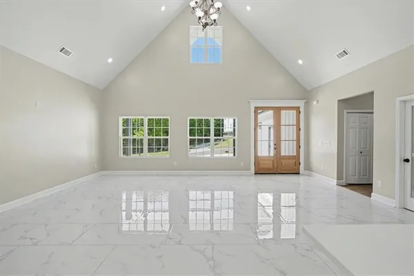 a large white kitchen with a large window