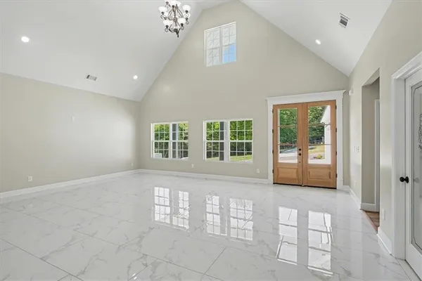 a large kitchen with kitchen island white cabinets and stainless steel appliances