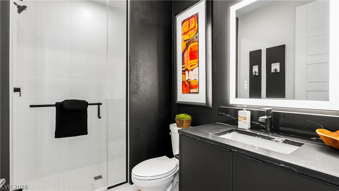 11099 Socrates Ridge Street Las Vegas, NV 89141 - Photo 11 of 29 This bathroom features a contemporary design with a sleek vanity and a spacious walk-in shower.