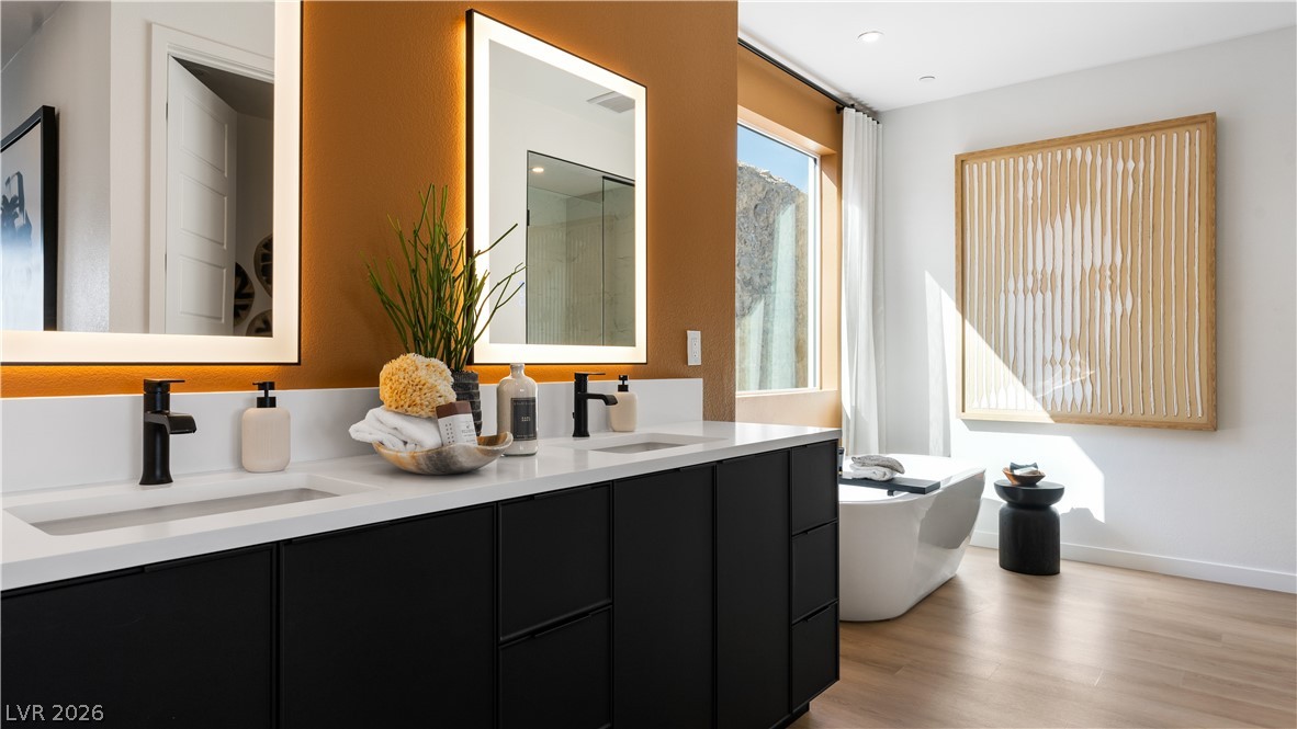 11099 Socrates Ridge Street Las Vegas, NV 89141 - Photo 13 of 29 This spacious primary bathroom features dual vanities and a soaking tub.