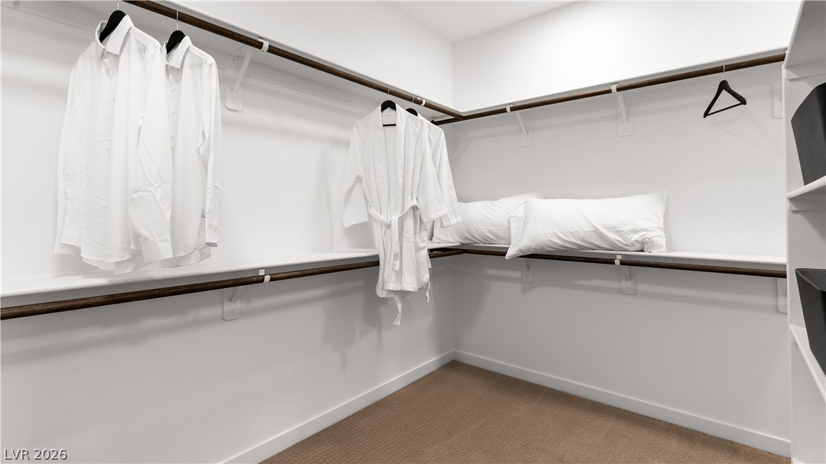 11099 Socrates Ridge Street Las Vegas, NV 89141 - Photo 16 of 29 This spacious walk-in closet offers ample storage and a neat, organized presentation.