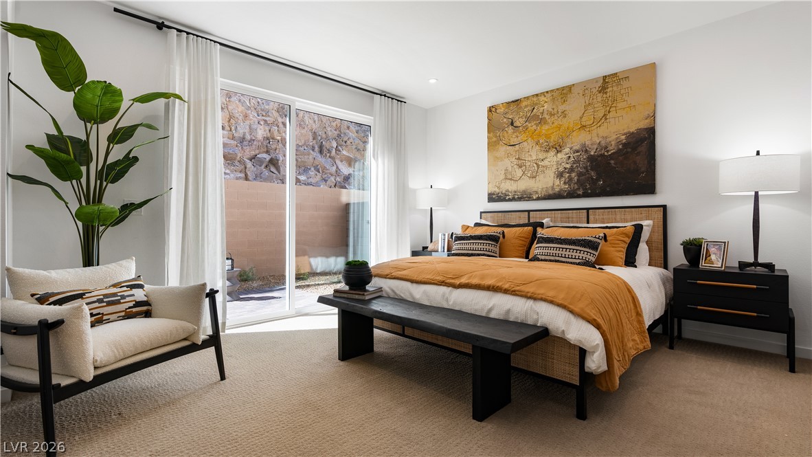 11099 Socrates Ridge Street Las Vegas, NV 89141 - Photo 18 of 29 This primary bedroom features expansive sliding glass doors and soft, inviting carpet.
