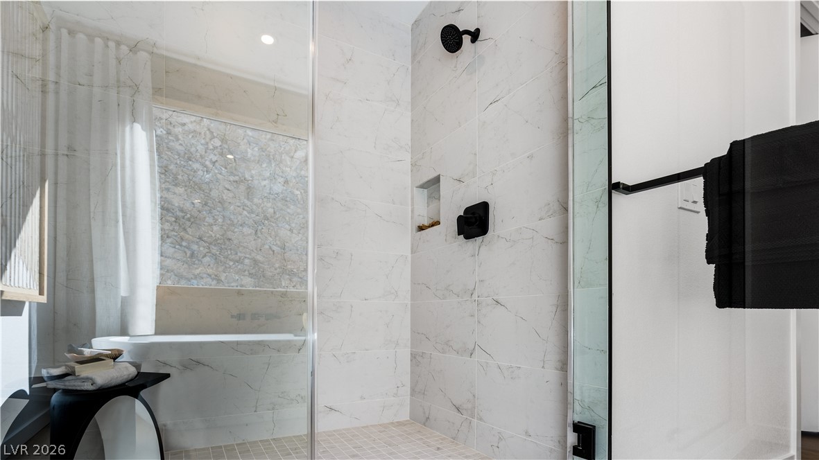 11099 Socrates Ridge Street Las Vegas, NV 89141 - Photo 20 of 29 This bathroom features a contemporary shower and a luxurious tub, perfect for unwinding.