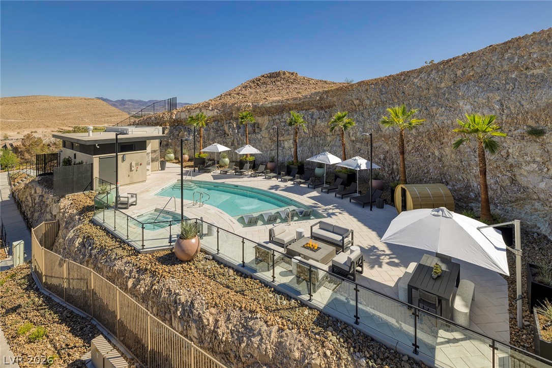 11099 Socrates Ridge Street Las Vegas, NV 89141 - Photo 22 of 29 Enjoy the refreshing pool and spa nestled against a beautiful rock face.