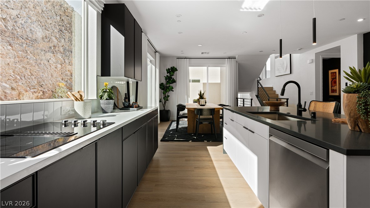 11099 Socrates Ridge Street Las Vegas, NV 89141 - Photo 4 of 29 This modern kitchen features a spacious island, sleek appliances, and an open-concept design.