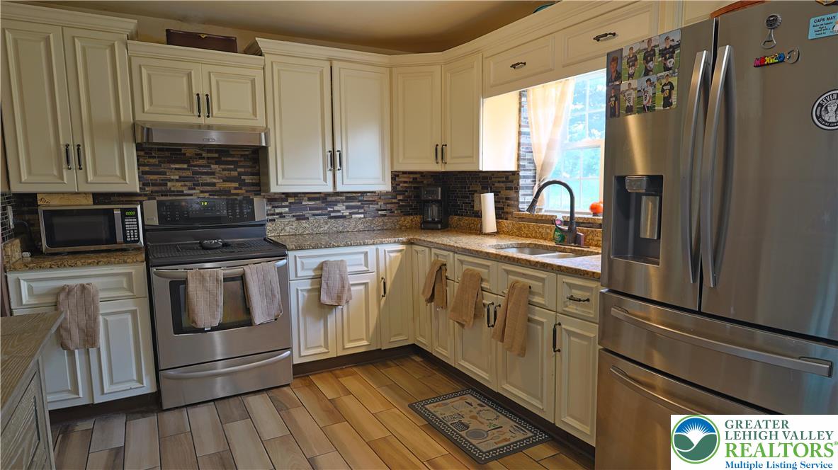 1345 Macada Road Bethlehem, PA 18017 - Photo 3 of 23 a kitchen with stainless steel appliances a refrigerator sink and cabinets