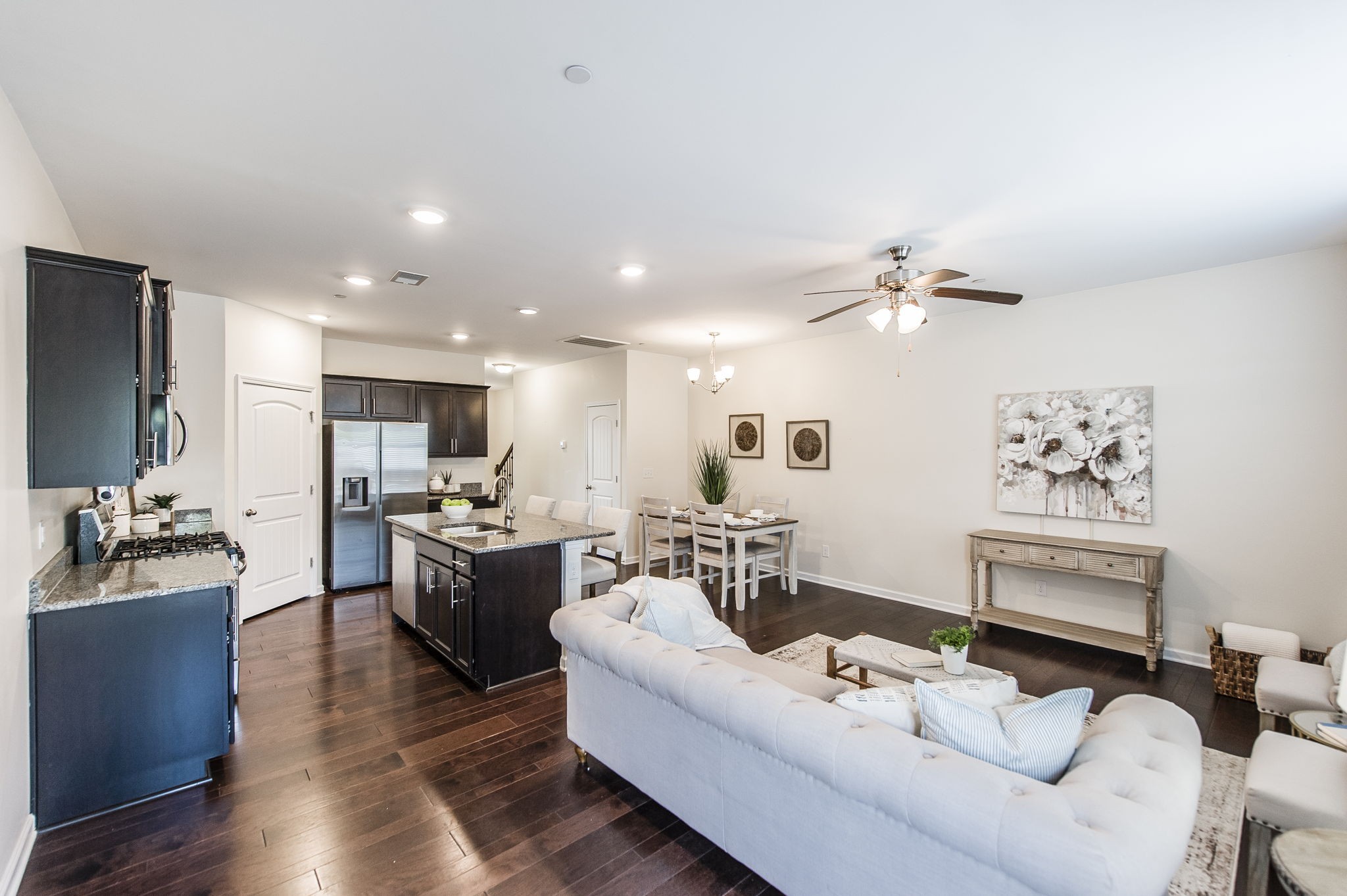 342 Manor Row Pleasant View, TN 37146 - Photo 18 of 45 a living room with furniture kitchen area and a wooden floor