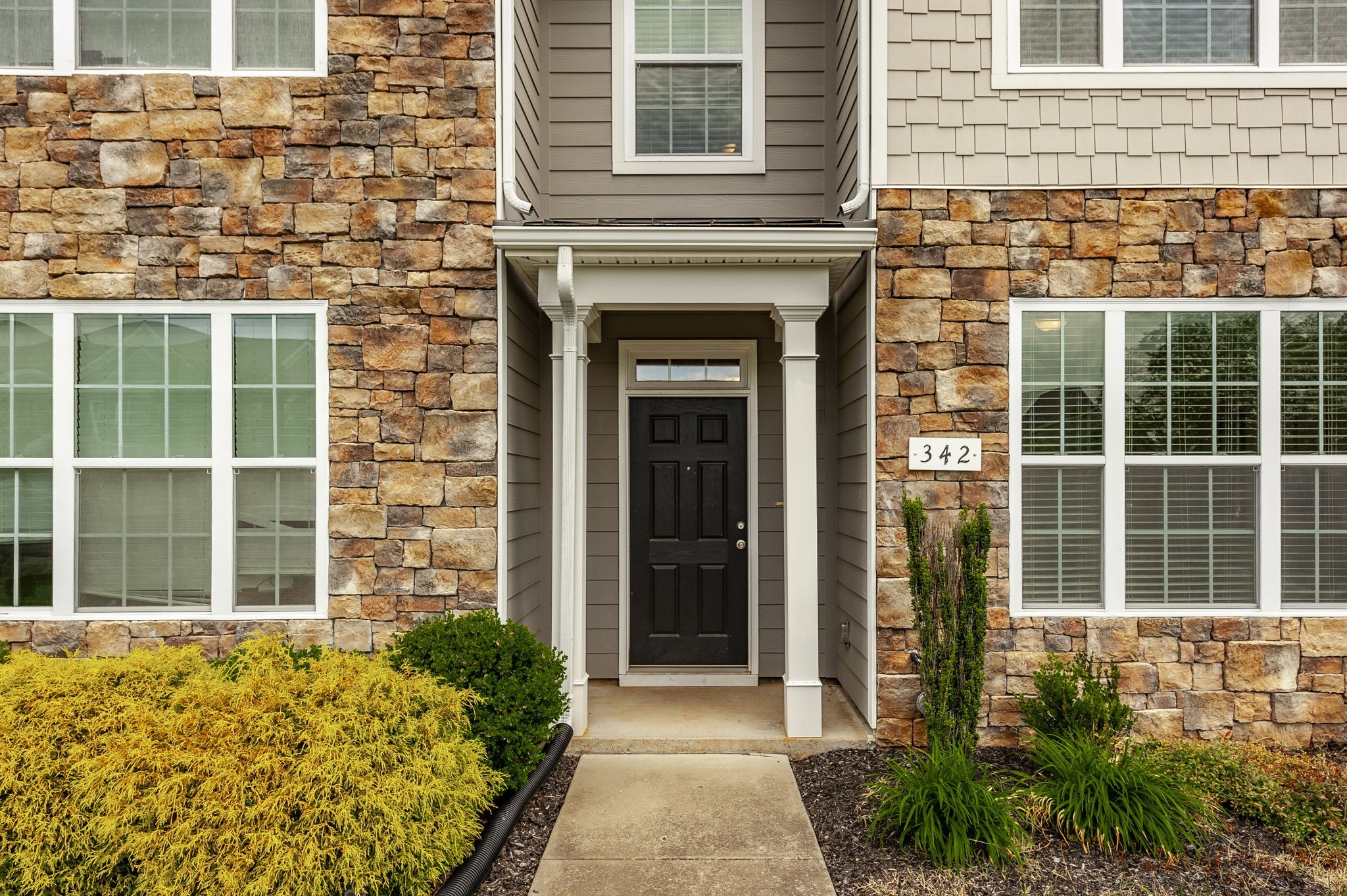 342 Manor Row Pleasant View, TN 37146 - Photo 4 of 45 a view of a brick house with a large windows