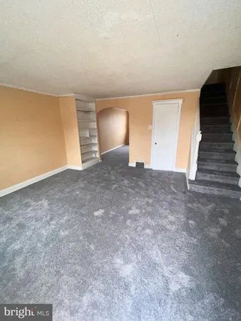 a view of an empty room with stairs and ventilation