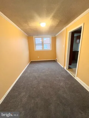 a view of an empty room and a window