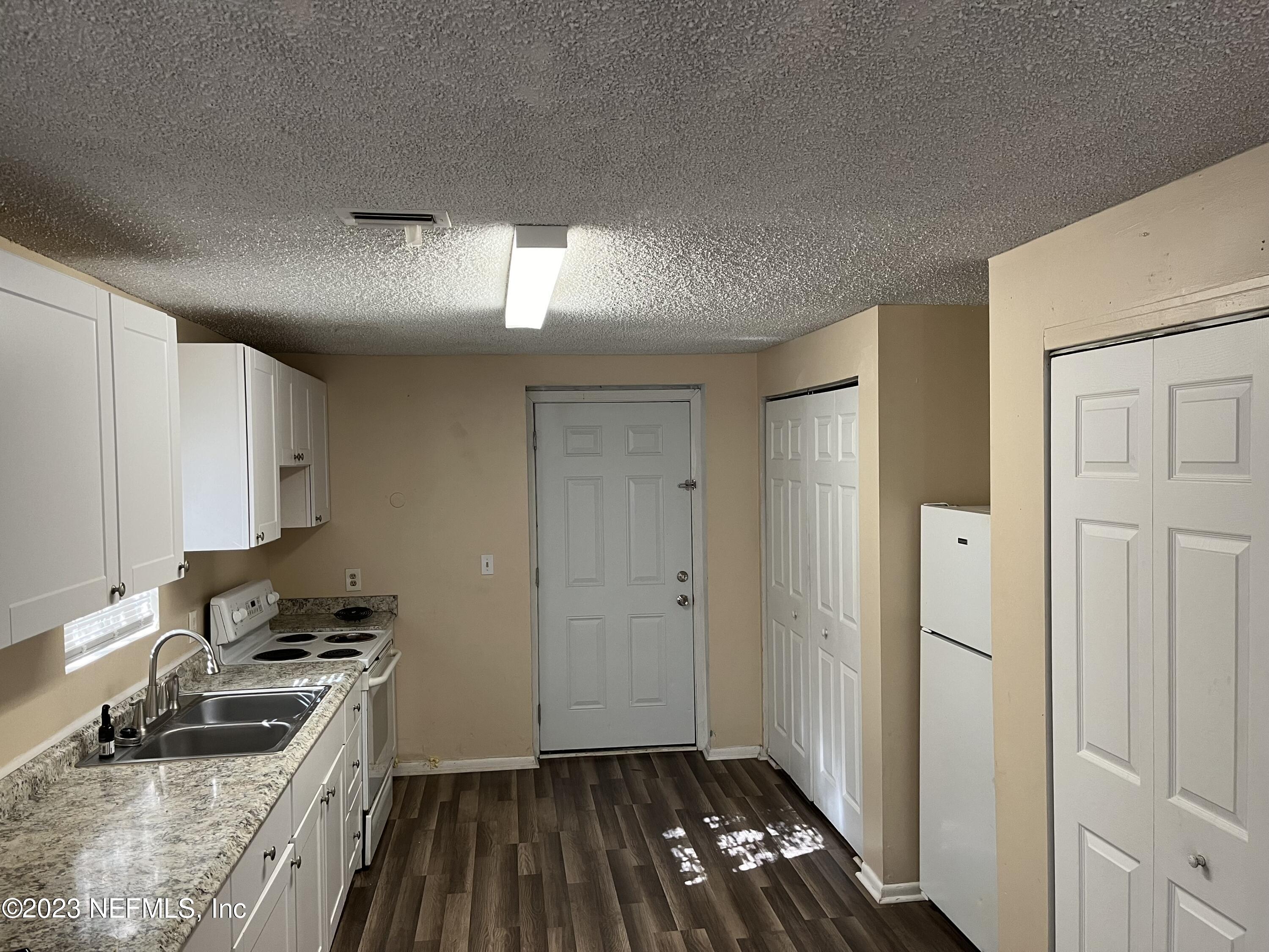 3716 Stuart Street Jacksonville, FL 32209 - Photo 3 of 13 a kitchen that has a sink and a stove