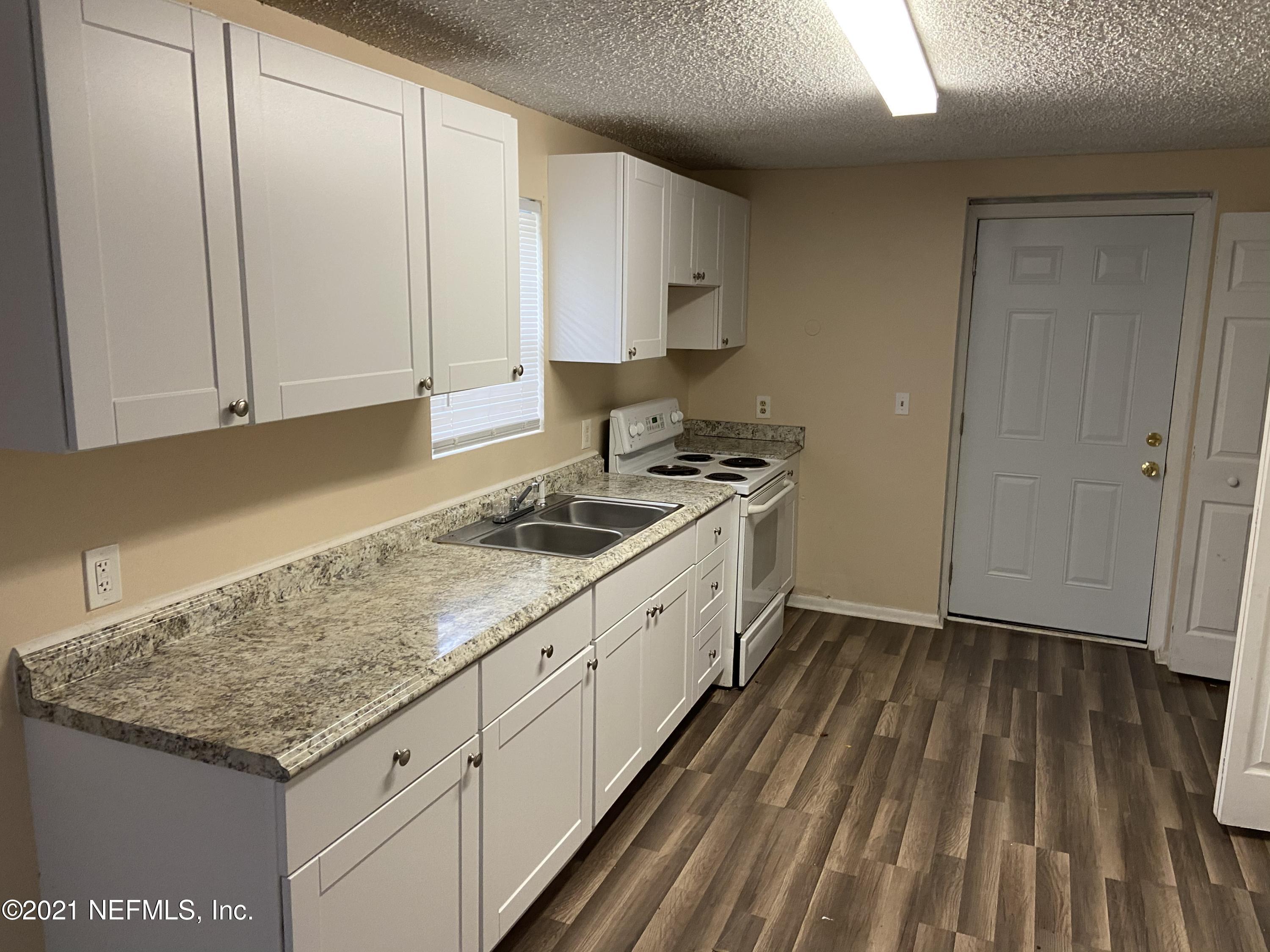 3716 Stuart Street Jacksonville, FL 32209 - Photo 4 of 13 a kitchen with granite countertop white cabinets and white appliances