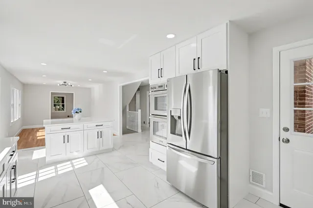 a kitchen with stainless steel appliances a refrigerator sink and microwave