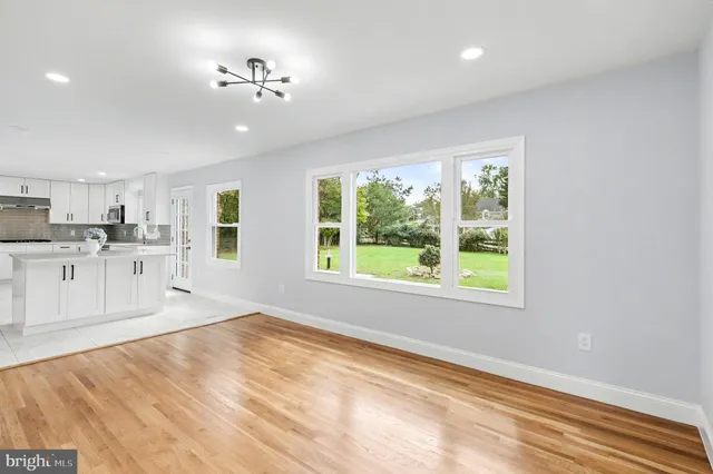 a view of a kitchen with wooden cabinet and a window