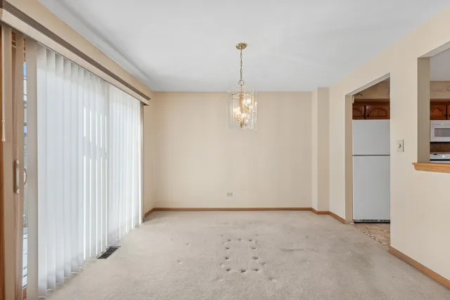 a view of a room with a window and chandelier