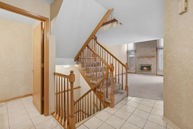 a view of staircase with railing and white walls