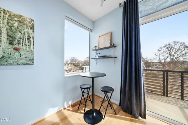 a kitchen with stainless steel appliances a sink dishwasher stove and microwave with wooden floor